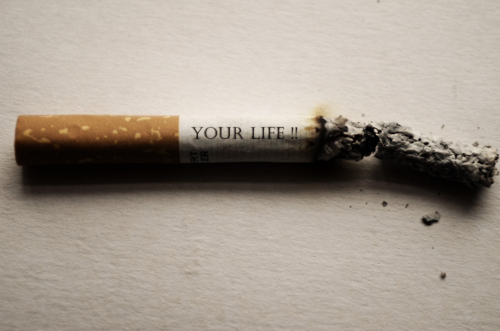 Burning Cigarrette on White Background